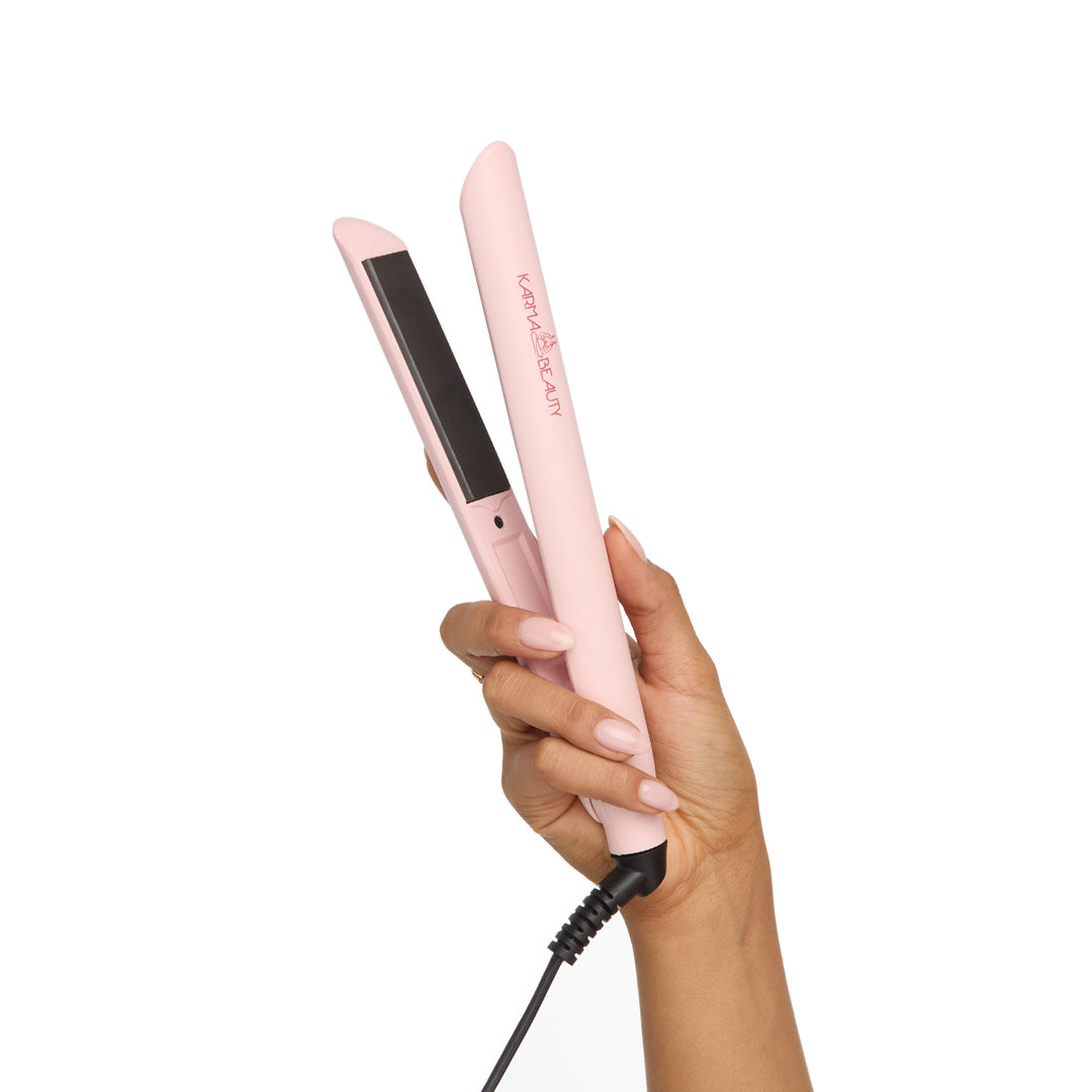 Pink straightener held by a hand 